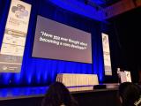 Savannah Bailey presenting the keynote with a slide reading 'Have you ever thought about becoming a core developer?'