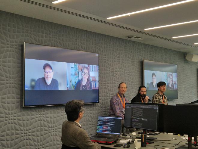 Steering Council Q&A: Greg, Pablo and Donghee on stools and Barry and Emily on screen.